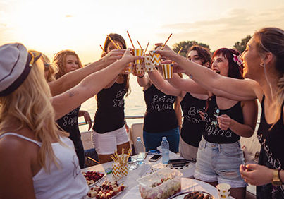 Bachelorette Party Cheers with gold cups at sunset